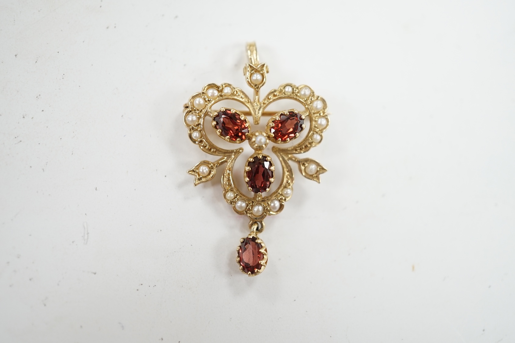 A Victorian style 9ct gold, garnet and seed pearl set drop pendant brooch, overall 39mm, gross weight 5.7 grams. Condition - fair to good